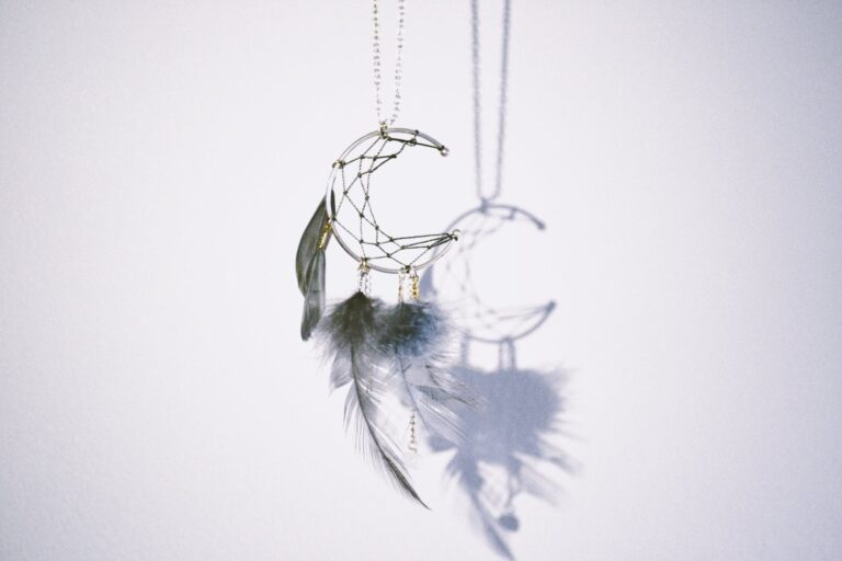 silver colored crescent moon pendant
