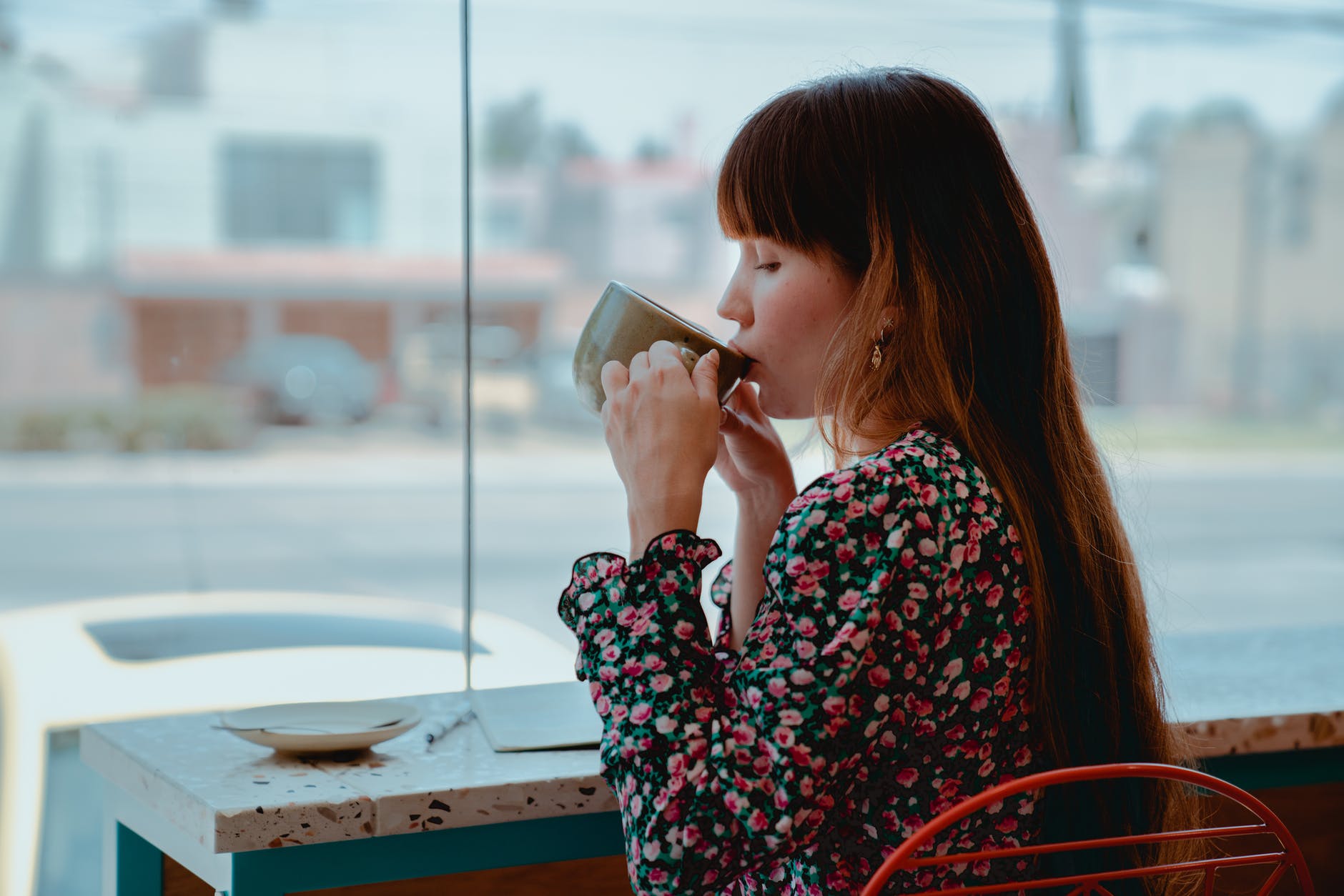 photo of woman sipping coffee