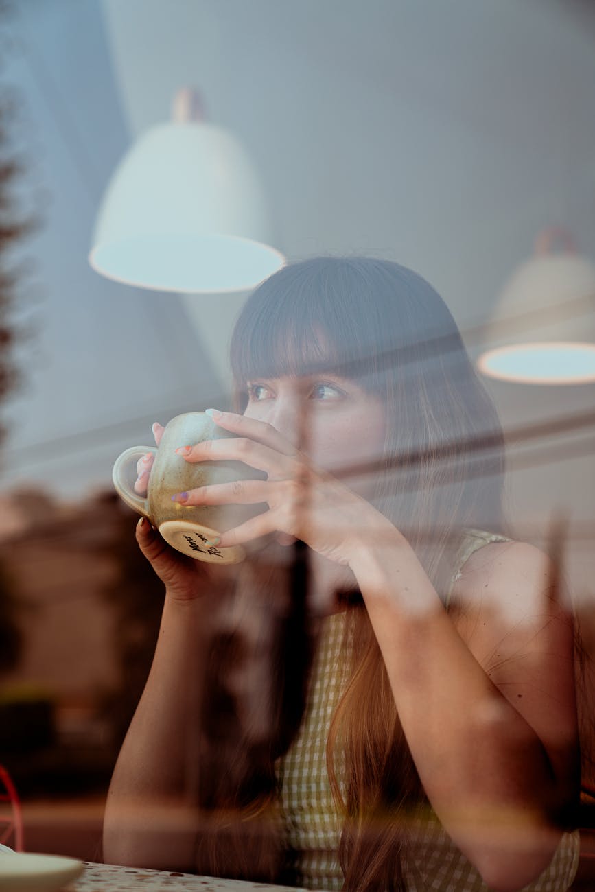photo of woman drinking coffee